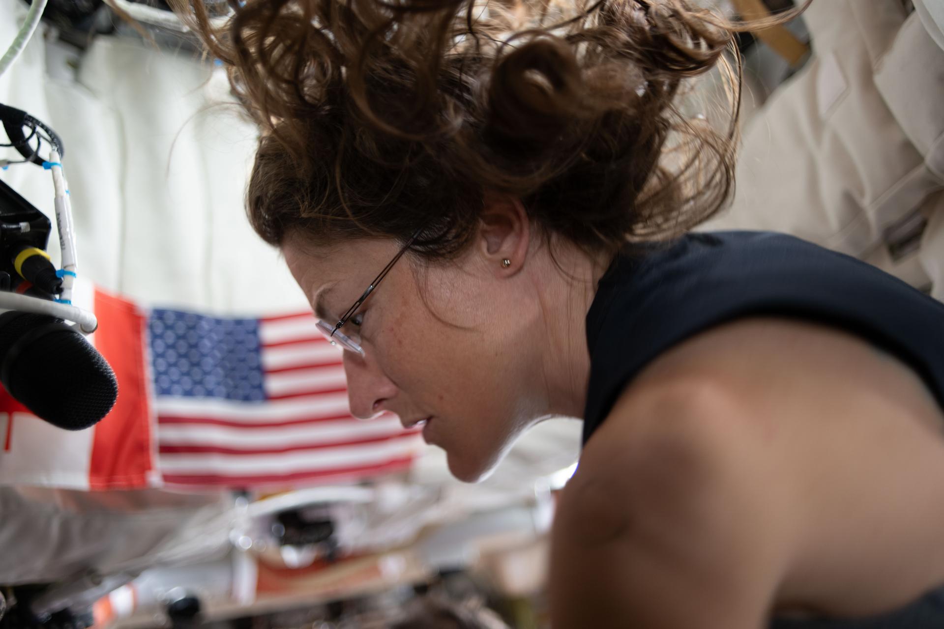Christina Koch looks out of the Orion spacecraft window at Earth
